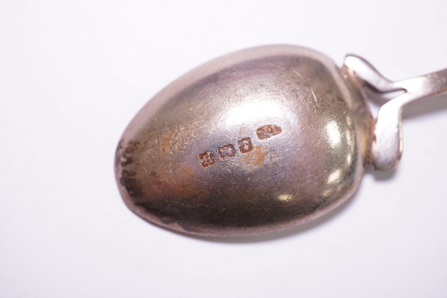 A cased Edwardian silver Christening trio, by Henry Wigful, Sheffield, 1909 and a cased set of eleven Edwardian silver coffee spoons and pair of sugar tongs, London, 1901/2 and one odd silver golf related teaspoon. Condi